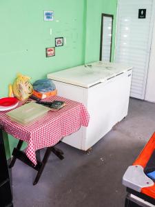 a kitchen with a table with a red and white table cloth at Espaço laser soberana in Guarulhos +21 photos