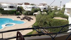 a view from a balcony of a resort with a swimming pool at MARIA HOSTEL FOREIGNERS ONLY-CRISS RESORT-NAAMA BAY-CITY CeNTER in Sharm El Sheikh