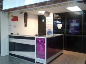 a restaurant with a counter with a purple item at Hornbill Resort Pangkor in Pangkor