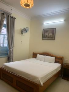 a bedroom with a bed in a room with a window at Areca Homestay in Hoi An
