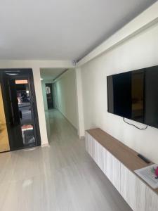 a living room with a flat screen tv on a wall at Comfortable apartment in Pereira