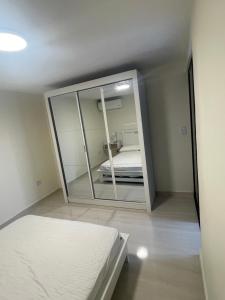 a bedroom with a mirror and a bed in it at Comfortable apartment in Pereira