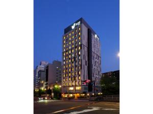 a tall building on a city street at night at Far East Village Hotel Yokohama - Vacation STAY 35287v in Yokohama