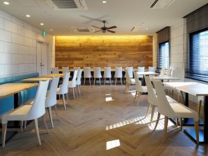 a dining room with tables and white chairs at Far East Village Hotel Yokohama - Vacation STAY 35241v in Yokohama
