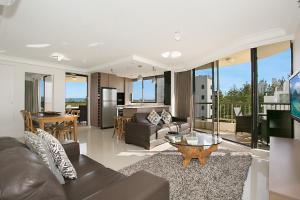 a living room with a couch and a table at Boulevard North Holiday Apartments in Gold Coast