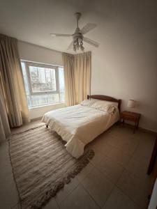 a bedroom with a bed and a ceiling fan at Edificio San Martin 2468 in Mar del Plata +222 photos