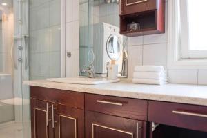 a bathroom with a sink and a shower at Modern Comfort with Panoramic view in Tromsø +19 photos
