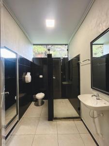 a bathroom with a shower and a toilet and a sink at Pousada M1 in União da Vitória +5 photos
