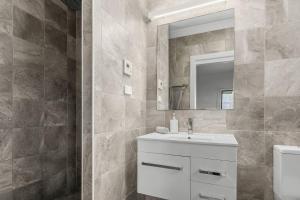 a bathroom with a sink and a mirror at Surf Haven Escape - Modern and Central in Thirroul in Thirroul +28 photos