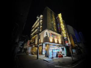 a building on a street at night at Hotel Lotus Yokohama in Yokohama