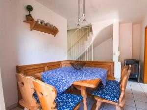 a dining room with a blue table and chairs at Holiday apartment Waxenstein in Garmisch
