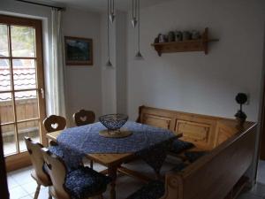 a dining room with a blue table and chairs at Holiday apartment Waxenstein in Garmisch +10 photos
