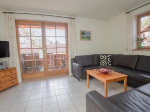 a living room with a couch and a coffee table at Holiday apartment Waxenstein in Garmisch