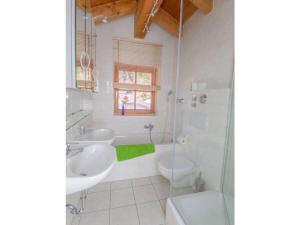 a bathroom with two sinks and a toilet and a shower at Holiday apartment Waxenstein in Garmisch