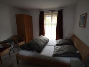 a bed sitting in a room with a window at Holiday apartment Kranzberg in Mittenwald