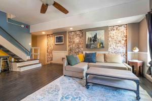 a living room with a couch and a table at 1918 Duplex with Character City Center in Philadelphia