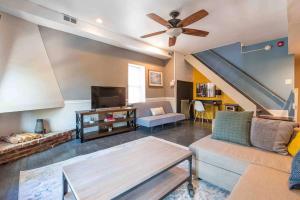 a living room with a couch and a ceiling fan at 1918 Duplex with Character City Center in Philadelphia