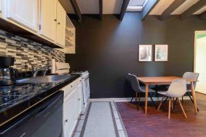 a kitchen with a sink and a table with chairs at 1918 Duplex with Character City Center in Philadelphia