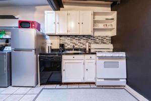 a kitchen with white appliances and white cabinets at 1918 Duplex with Character City Center in Philadelphia +24 photos
