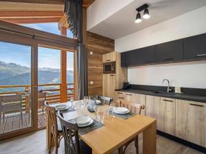 a kitchen and dining room with a table and chairs at Confort à Les Saisies, appartement pour 6 personnes avec parking - FR-1-809-28 in Les Saisies