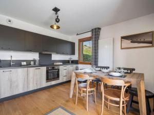 eine Küche mit einem Holztisch und Stühlen darin in der Unterkunft Appartement 3 pièces pour 6 personnes avec garage aux Saisies - FR-1-809-25 in Les Saisies + 2 Fotos