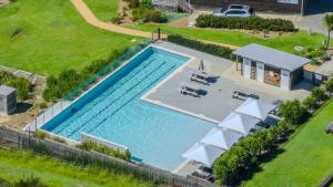 an overhead view of a swimming pool with a yard at Villa Oceania at Caves Beach Villas in Caves Beach