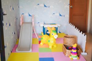 a childs play room with a slide and toys at Ubu Villa Lemme with Rustic Mediterranean Style in Adi Sutjipto