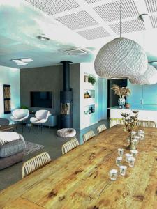 a living room with a large wooden table with chairs at Family Cabin With Sea View On Talgje in Talgje +32 photos