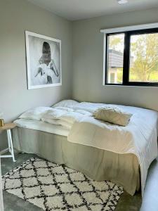 a large bed in a bedroom with a window at Family Cabin With Sea View On Talgje in Talgje