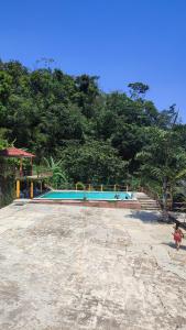 an empty swimming pool with trees in the background at Finca San Antonio in Pluma Hidalgo