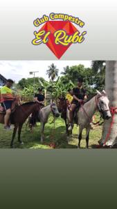 a group of people riding on horses in the grass at Club Campestre El Rubí in Carmen de Apicalá +16 photos