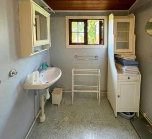 a small bathroom with a sink and a window at Historic Vicarage By The Lake In Dalskog in Dalskog +32 photos