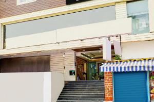 a building with a blue door in front of it at Super Townhouse MG Road Near Commercial Street in Bangalore +30 photos