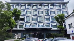 a building with a blue and white building at Juyue hotel Hongqiao Airport in Shanghai