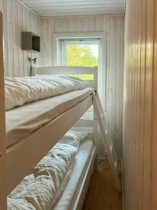 two bunk beds in a room with a window at Cabin With Views Over Straumsundet in Øygarden