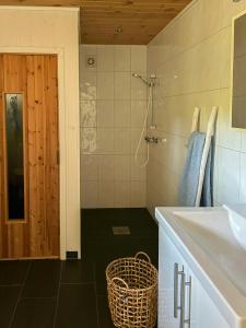 a bathroom with a sink and a mirror and a shower at Cabin With Views Over Straumsundet in Øygarden +24 photos