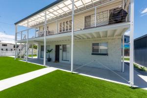 a view of a house with a balcony at Coastal Getaway - Walk to Beach in Urangan