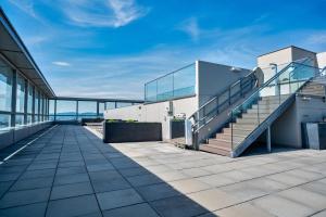 a balcony of a building with stairs and views of the ocean at High Rise Balcony I Roof Top Pool I Close to Metro in Vienna