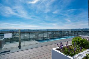 a balcony with a swimming pool on a building at High Rise Balcony I Roof Top Pool I Close to Metro in Vienna