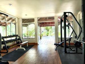 a gym with two treadmills and a treadmill at Nataya Round House Coral Bay Resort in Kampot