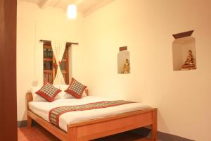 Postel nebo postele na pokoji v ubytování Hiranya Guest House