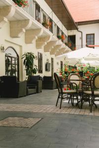 an outdoor patio with chairs and tables and umbrellas at Le Petit Paris in Cluj-Napoca