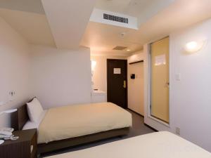 a hotel room with two beds and a desk at Ikebukuro Royal Hotel Higashiguchi in Tokyo +56 photos