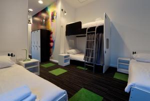 a dorm room with two beds and green accents at Hostel 365 For U in Dubrovnik