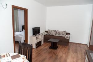 a living room with a couch and a table at Villa Maria in Tsarevo