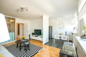 a kitchen and living room with a table and a dining room at Hendrix Bridge Apartment in Zagreb