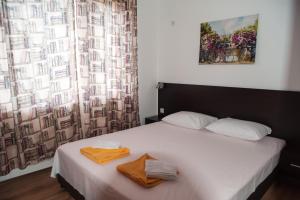 a bedroom with a bed with two towels on it at Villa Maria in Tsarevo