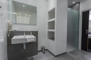 a bathroom with a sink and a mirror at ProfilHotels Mercur in Copenhagen