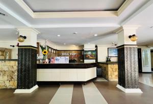 a restaurant with a counter in a building at Cebu Hilltop Hotel in Cebu City