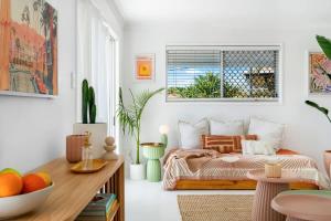 a living room with a bed and a table at The Springs Villa 1 in Urangan